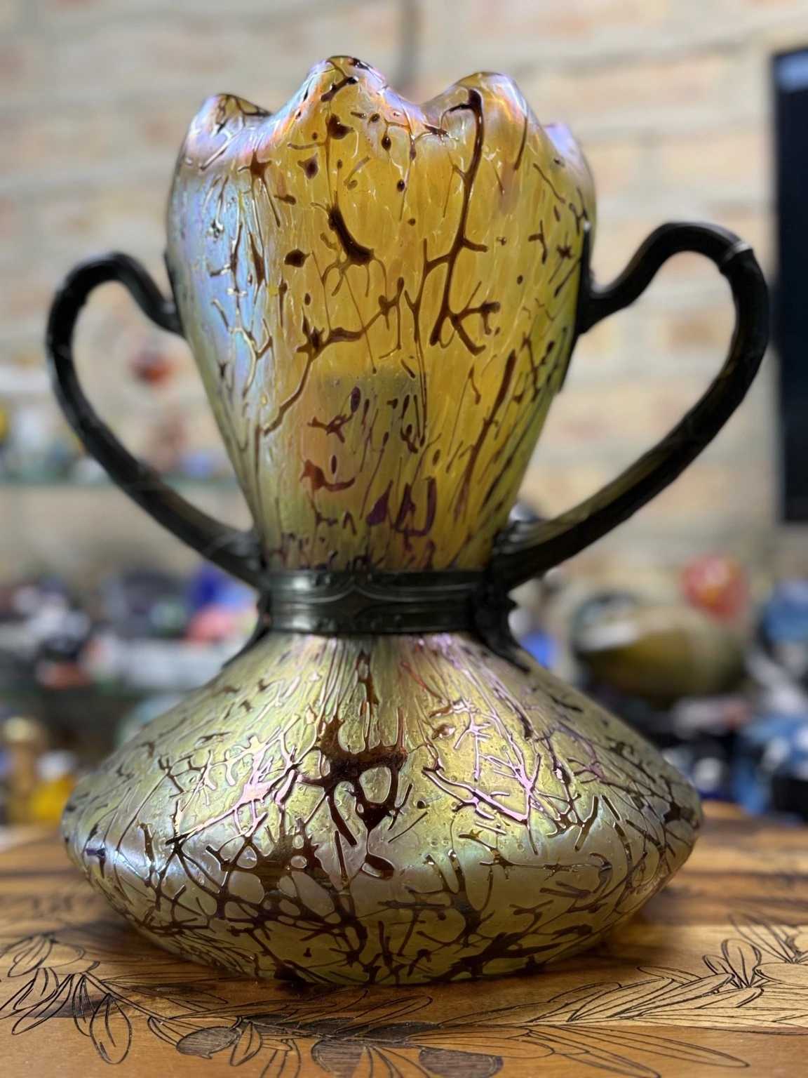 Iridescent amber art glass handled vase